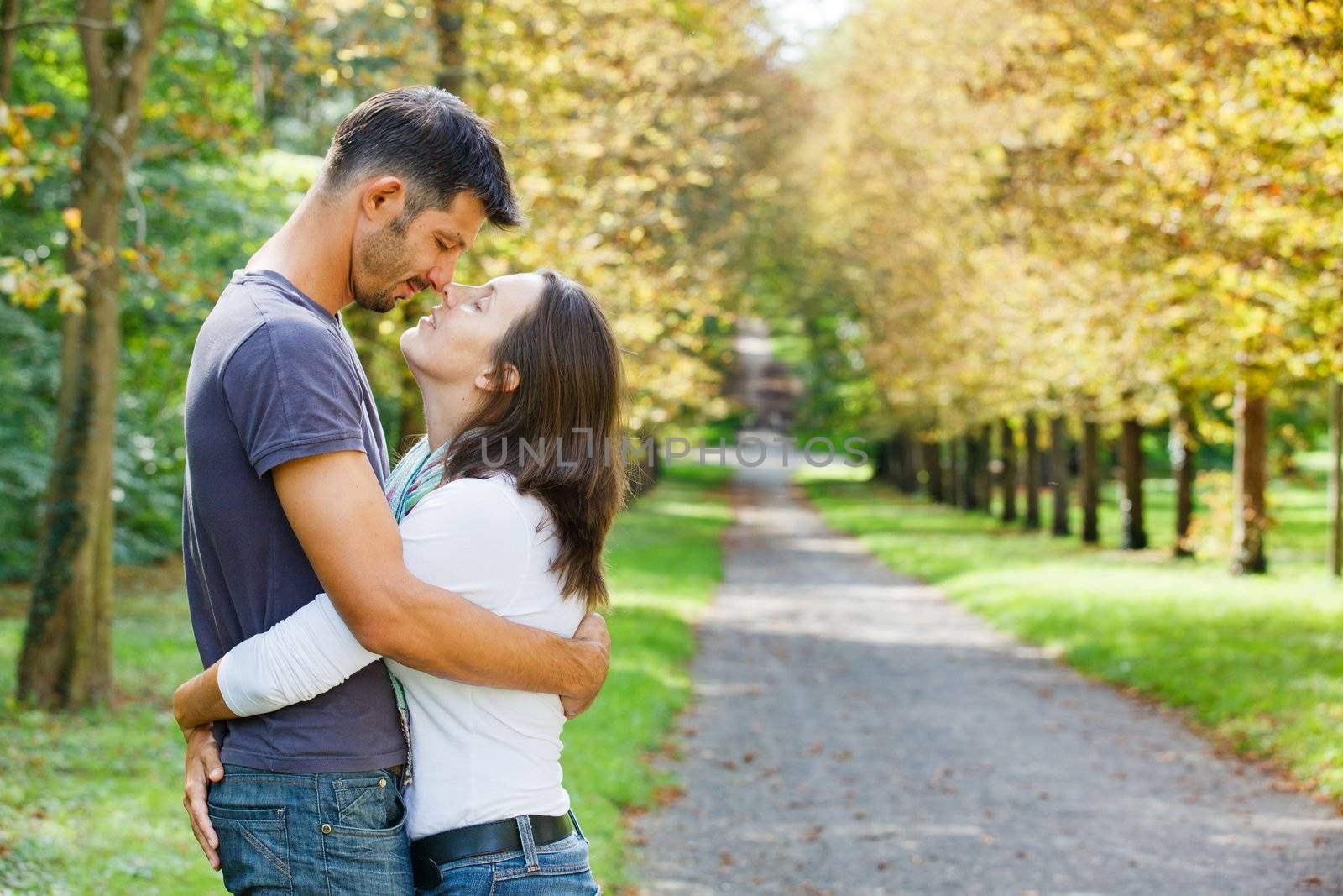 Romantic  Beautiful young couple walking in autumn park