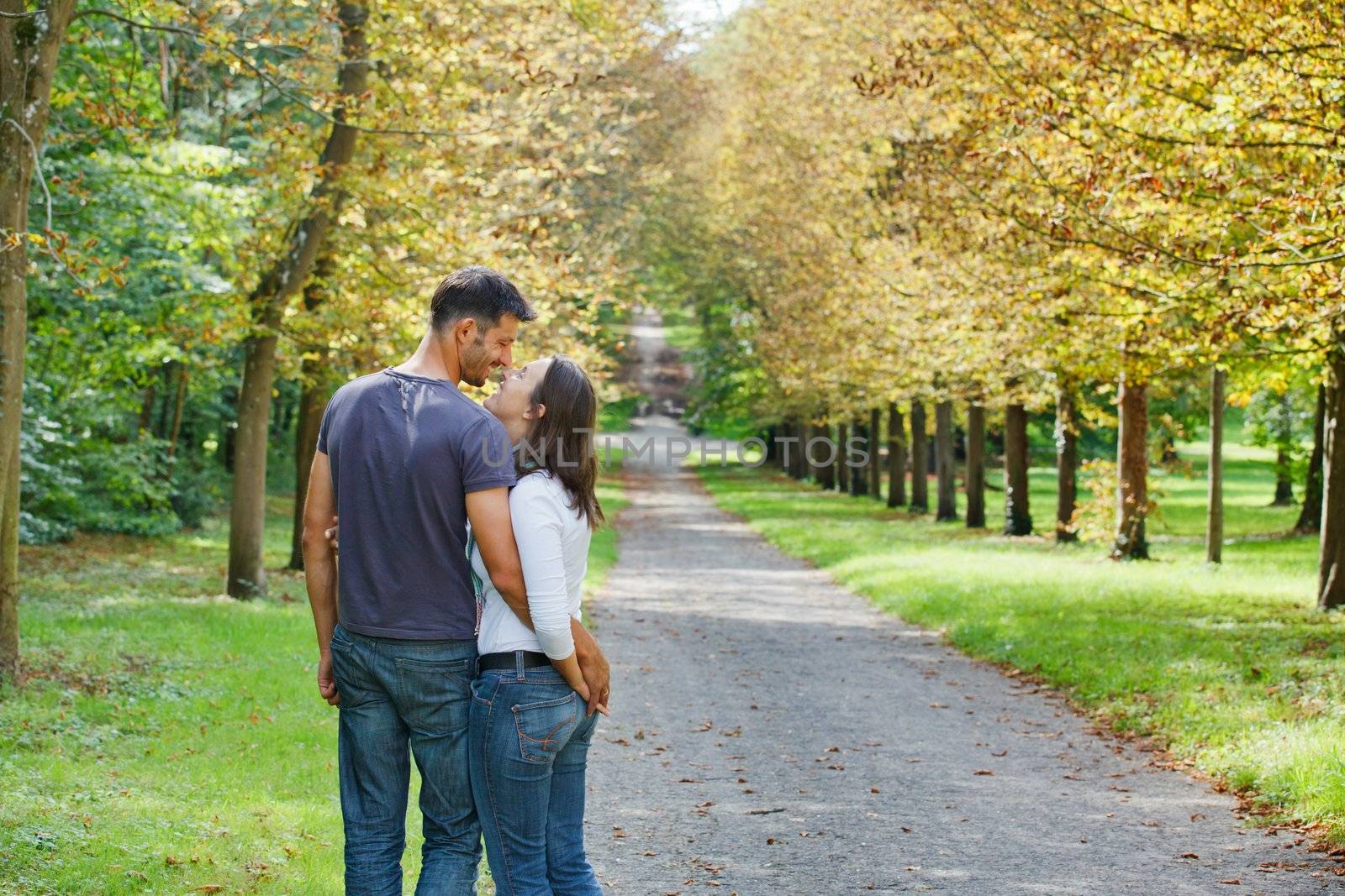 Romantic  Beautiful young couple walking in autumn park