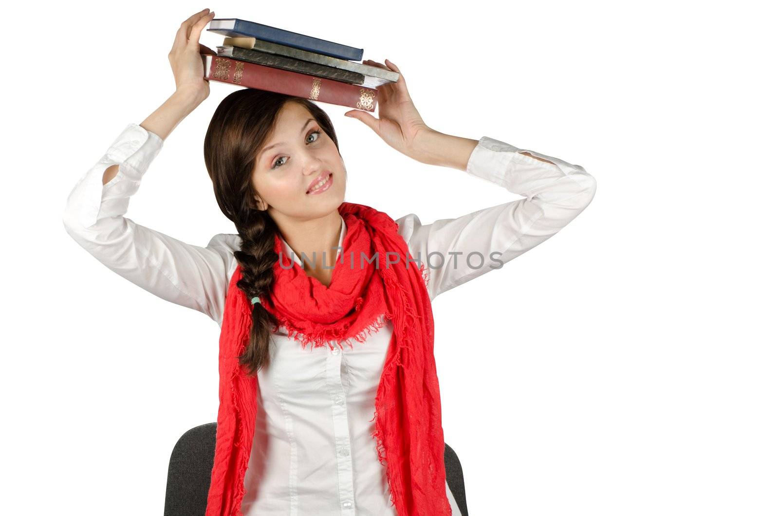 Young student girl with her books in hand at head, smiling and looking at the camera