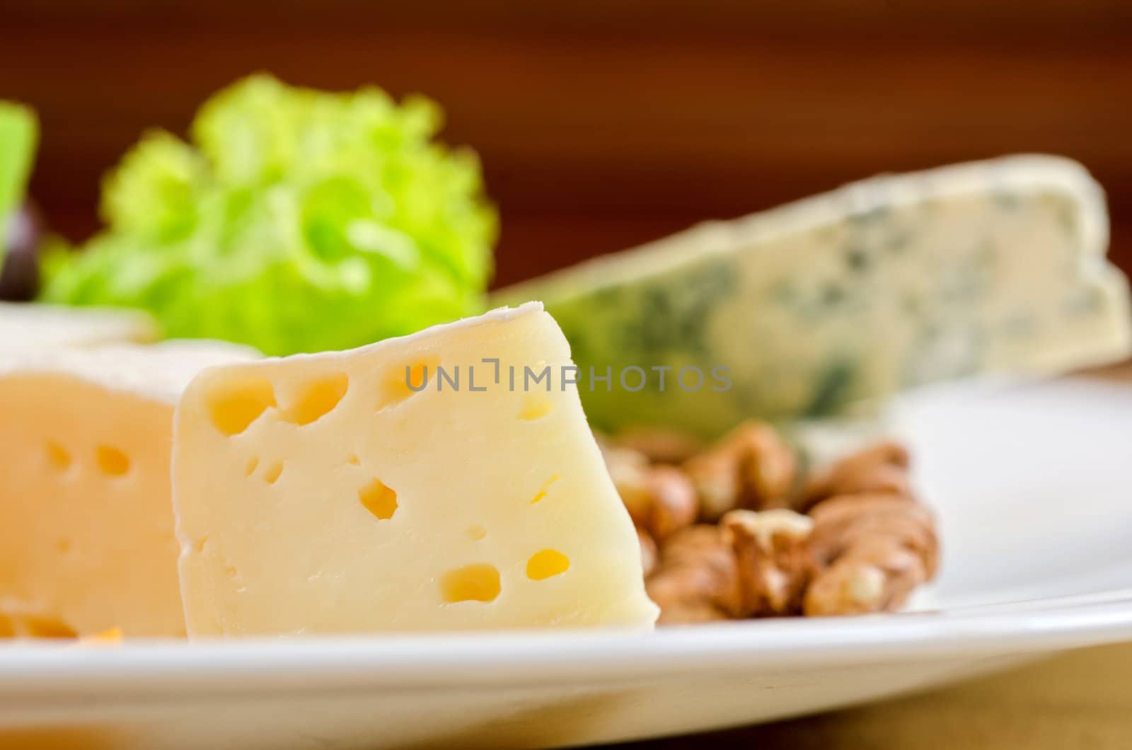 cheese with lettuce, grapes and nuts closeup