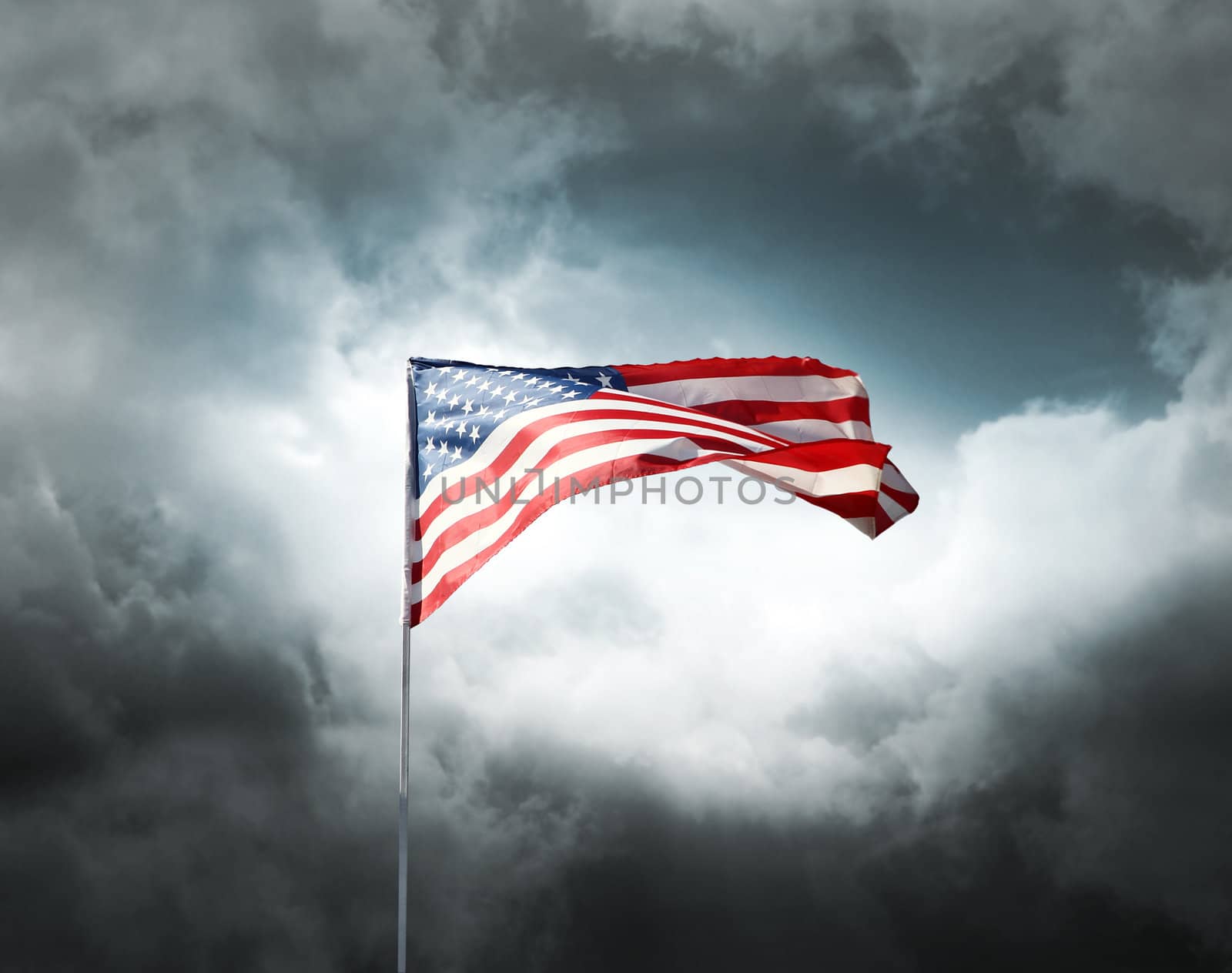 American flag on a dark cloudy dramatic sky