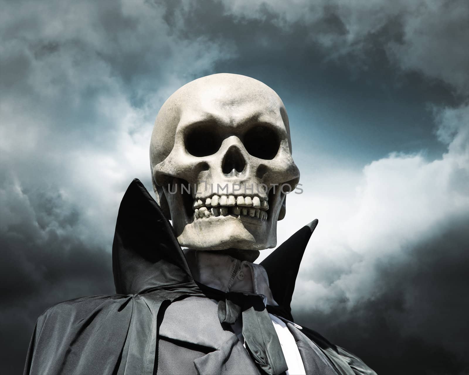 grim reaper. death's skeleton on a cloudy dramatic sky by daboost