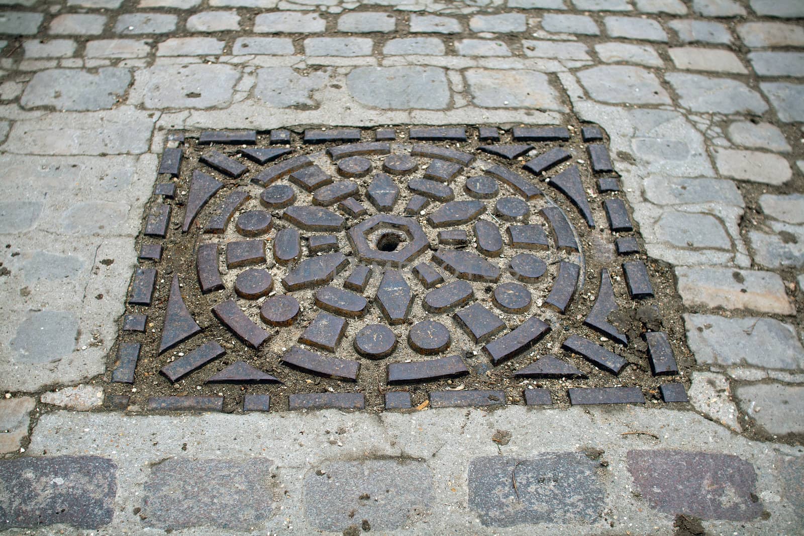 sewer's patch encircled of beautiful stones