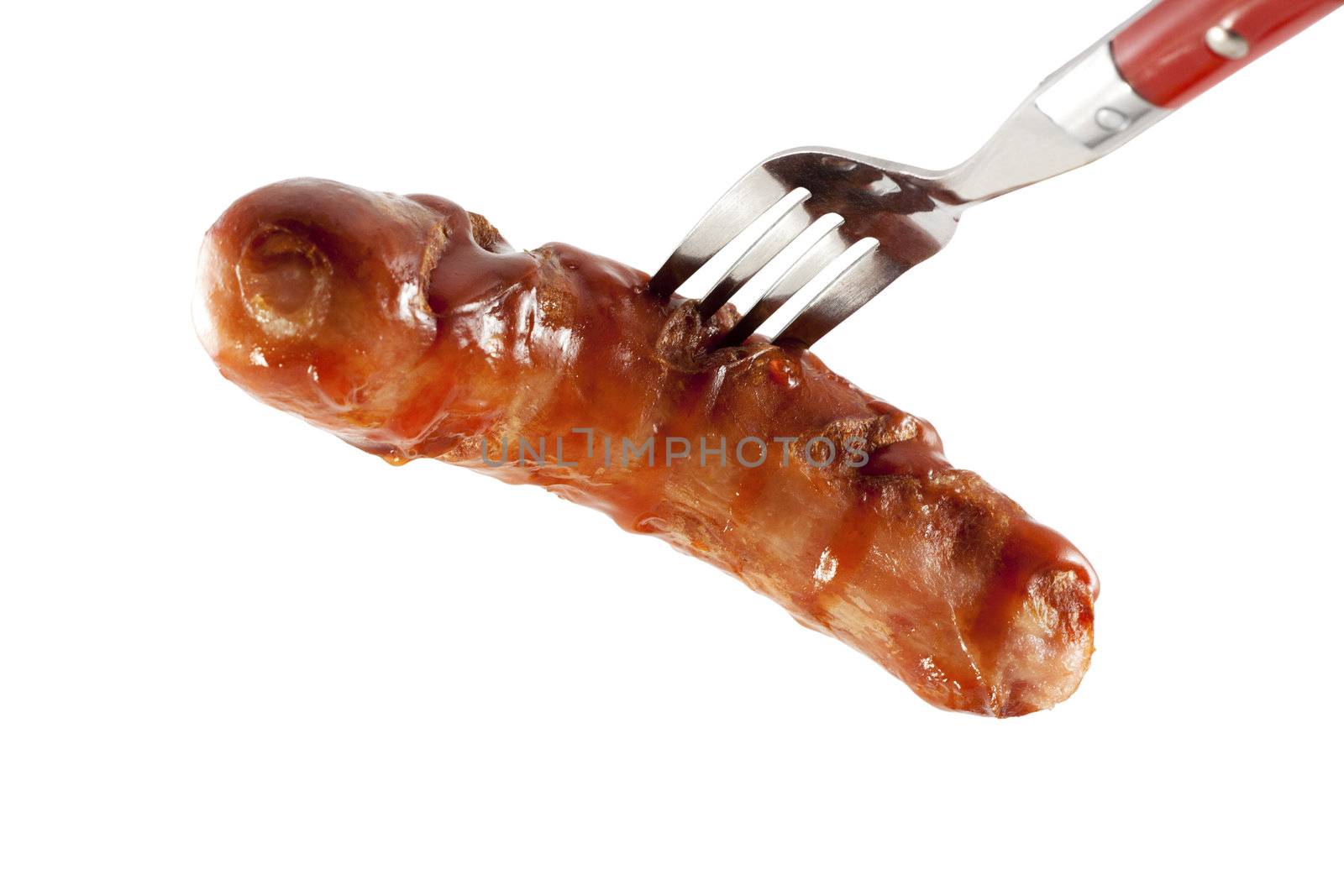Fried sausage on a fork isolated on white