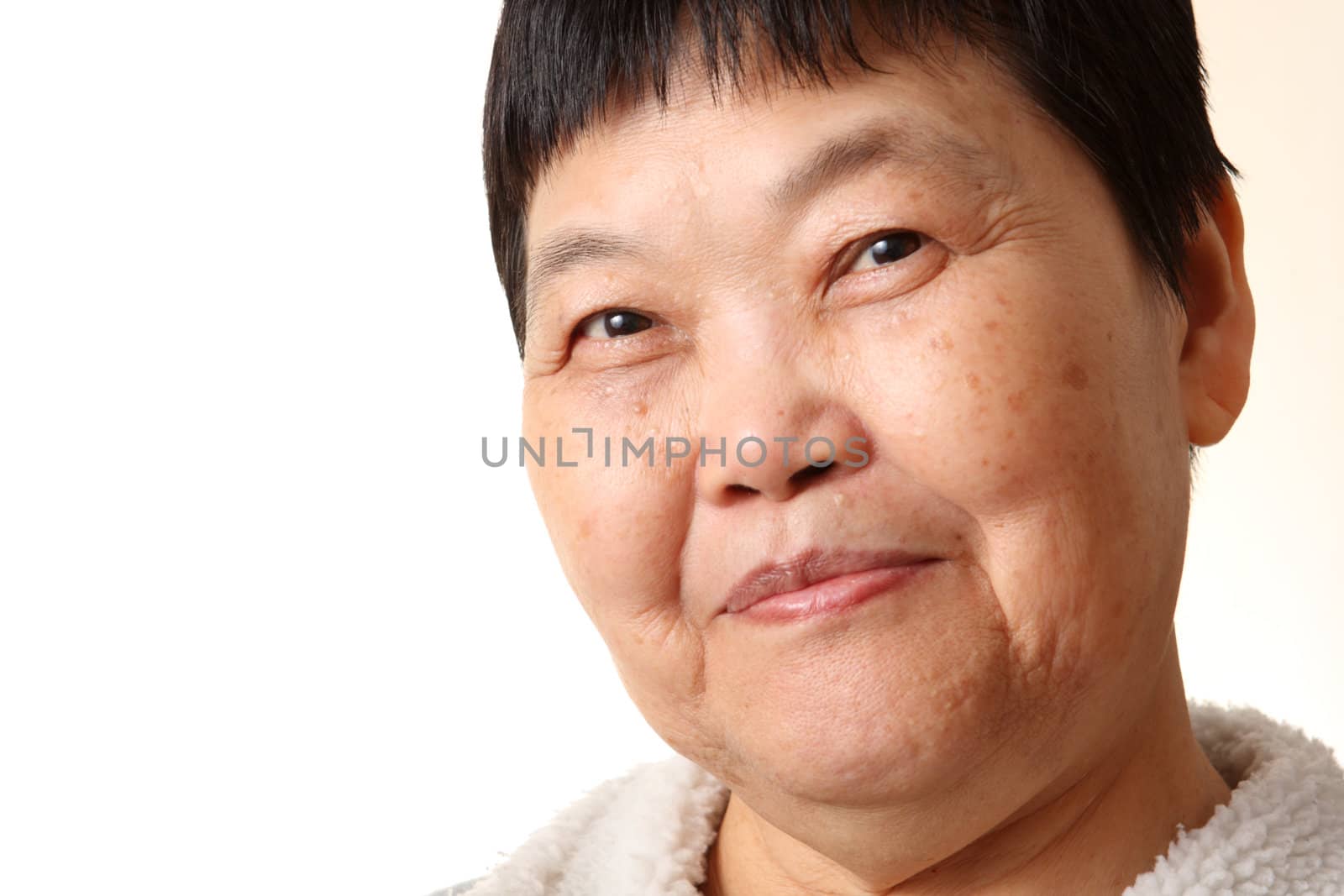 Studio Portrait Of Smiling Senior Woman  by cozyta