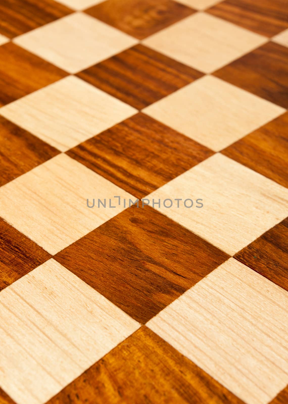 Wooden chess board with brown and yellow squares background . Natural wood