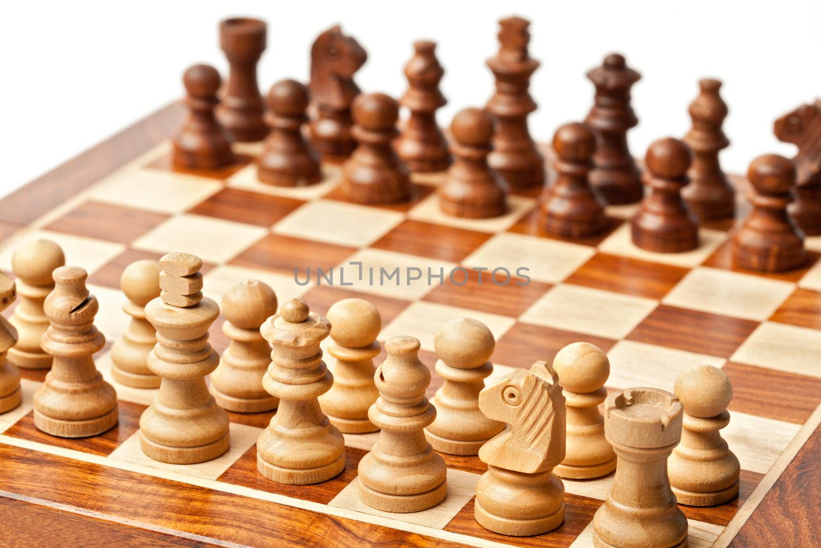 Wooden chess pieces on chessboard. Selective focus, shallow depth of field