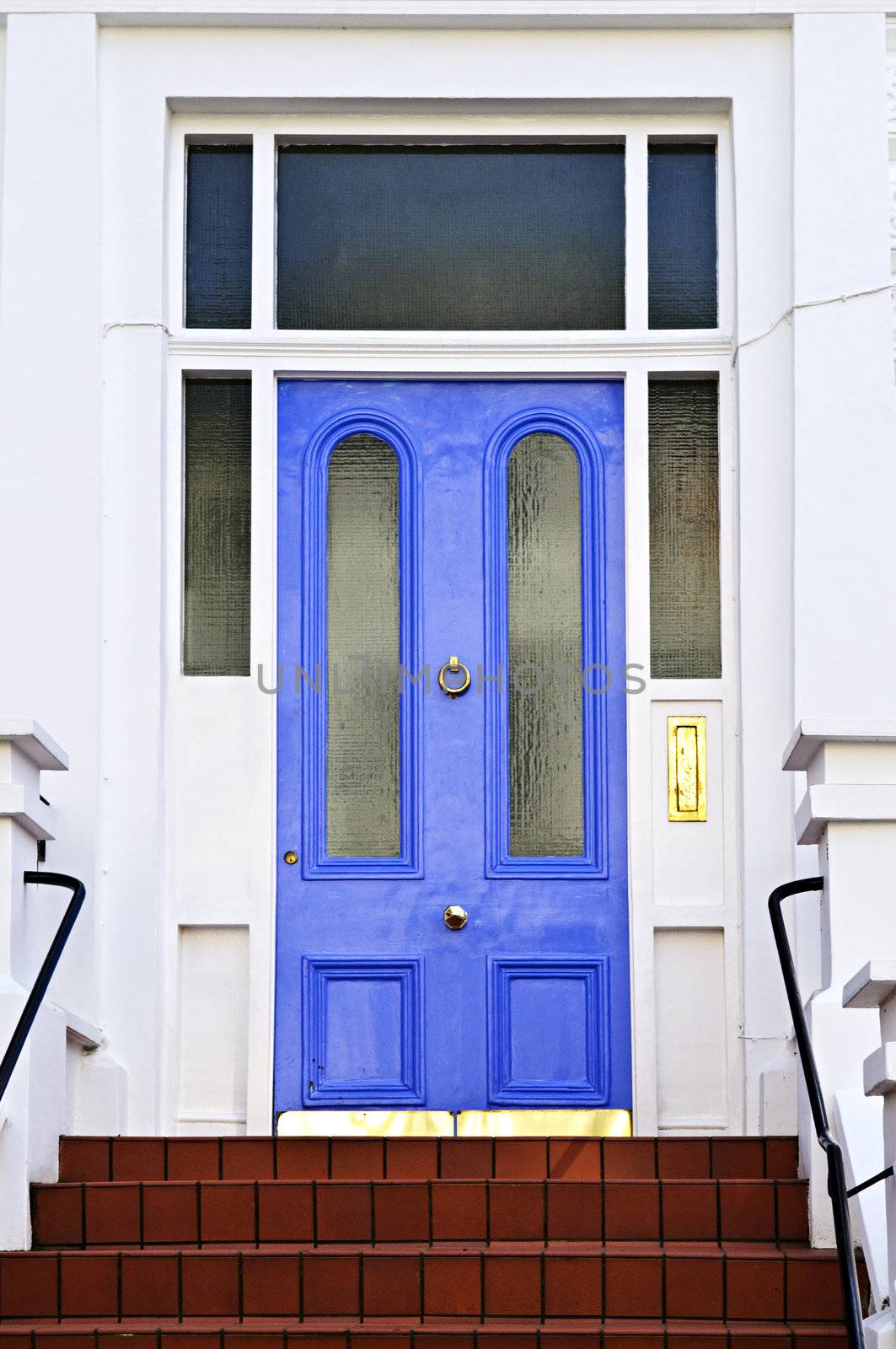 Blue front door with brass knocker in London England