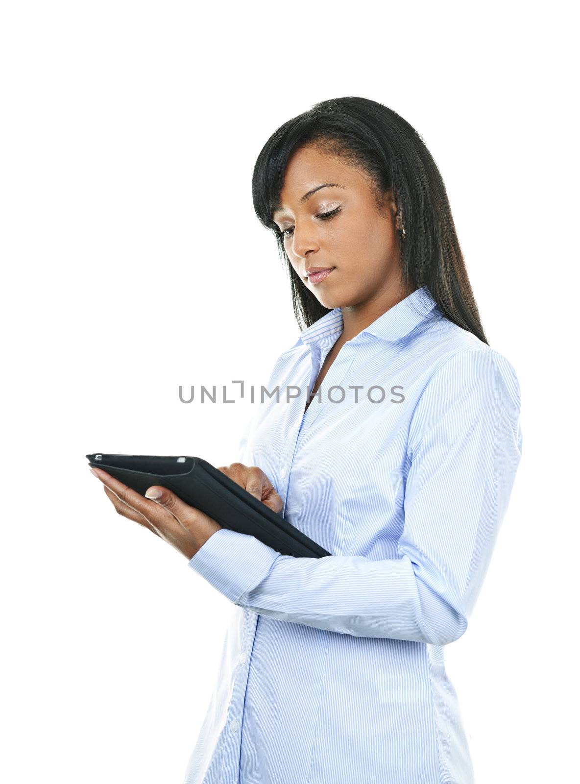Young serious black woman working with tablet computer
