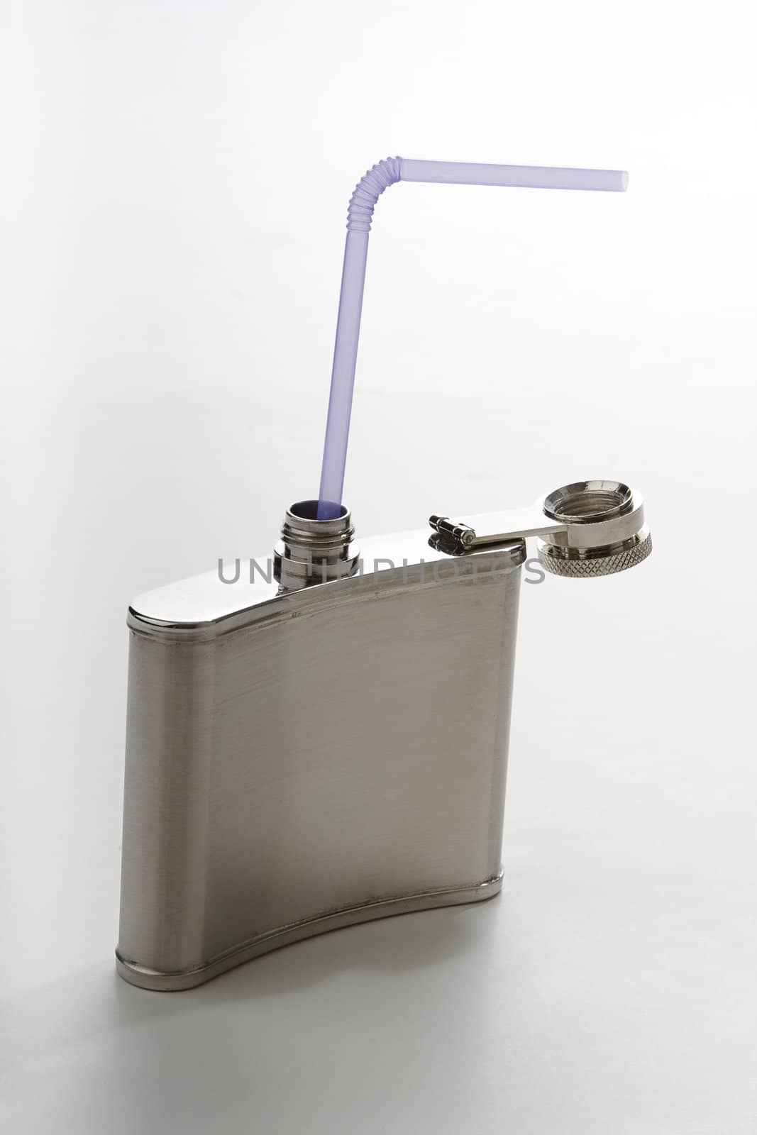 metal flask with purple straw against a white background