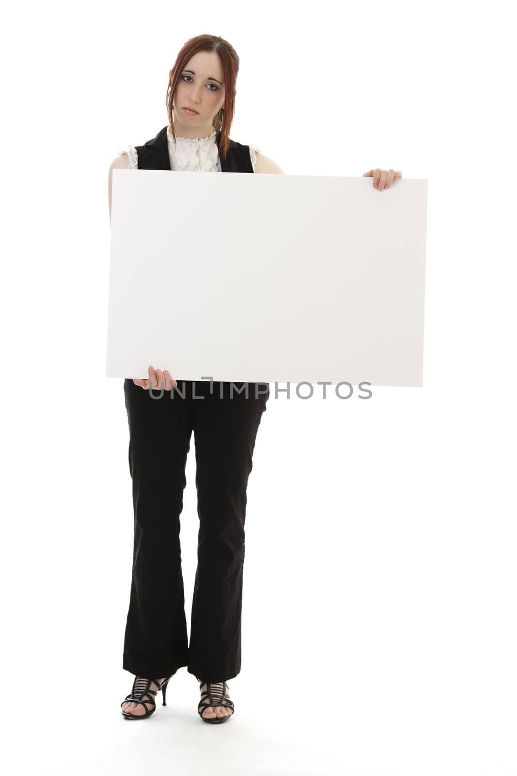 Young woman in business suit holding a white sign with a sad expression against a white background