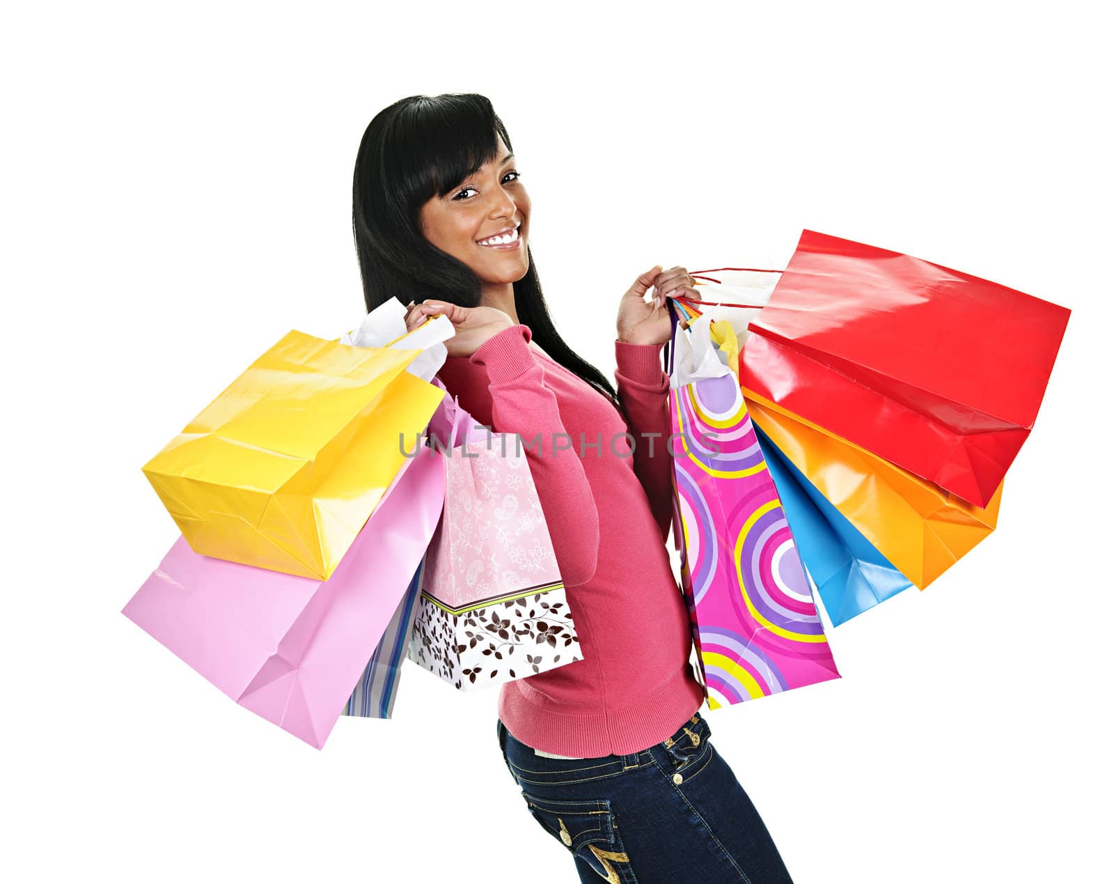 Happy young black woman with shopping bags by elenathewise