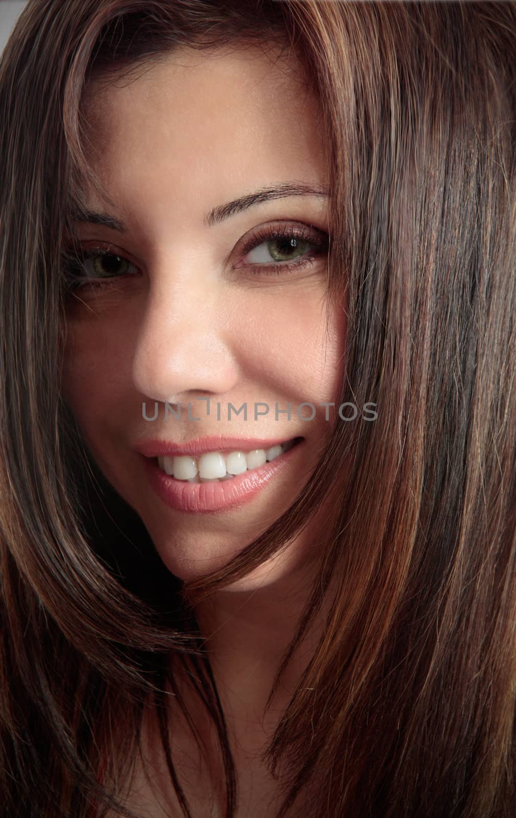 Beautiful woman with long brown hair smiling.