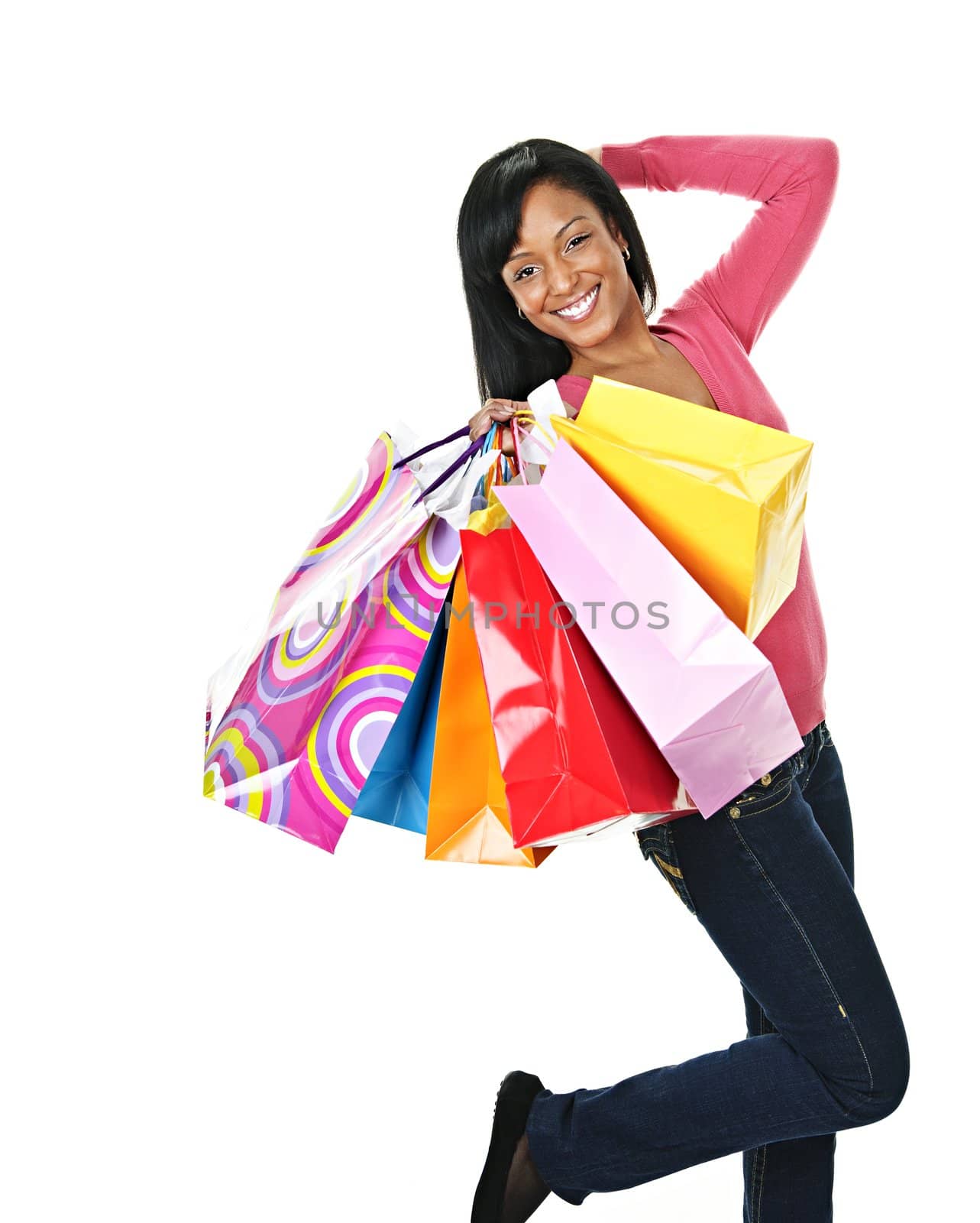 Young excited black woman with shopping bags by elenathewise