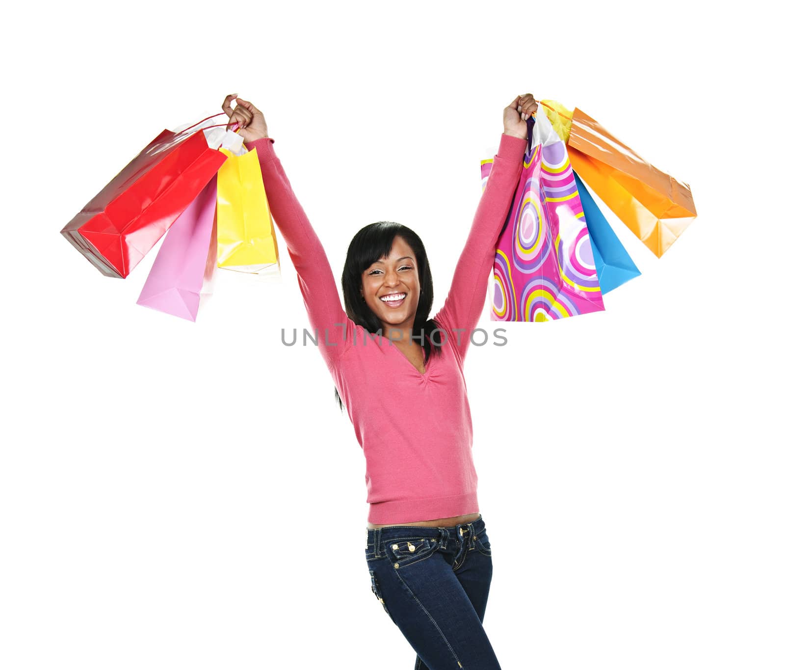 Excited young black woman with shopping bags by elenathewise