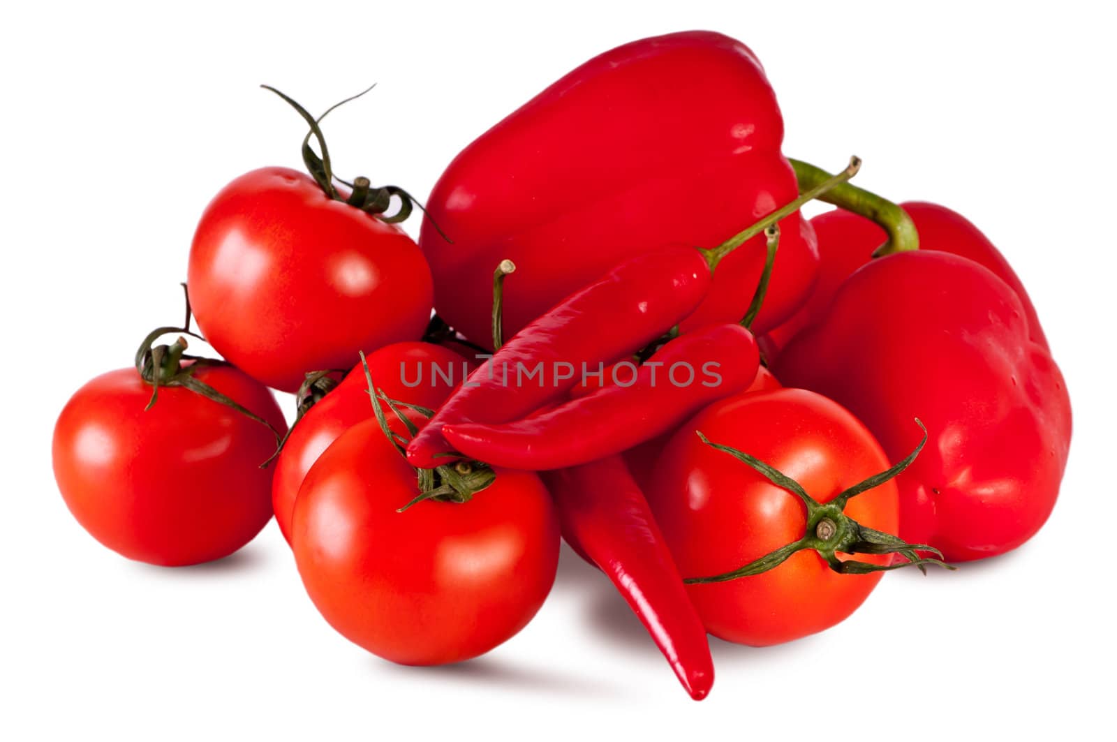Peppers, tomatoes, lie on the white table. Vegetables on a white background.