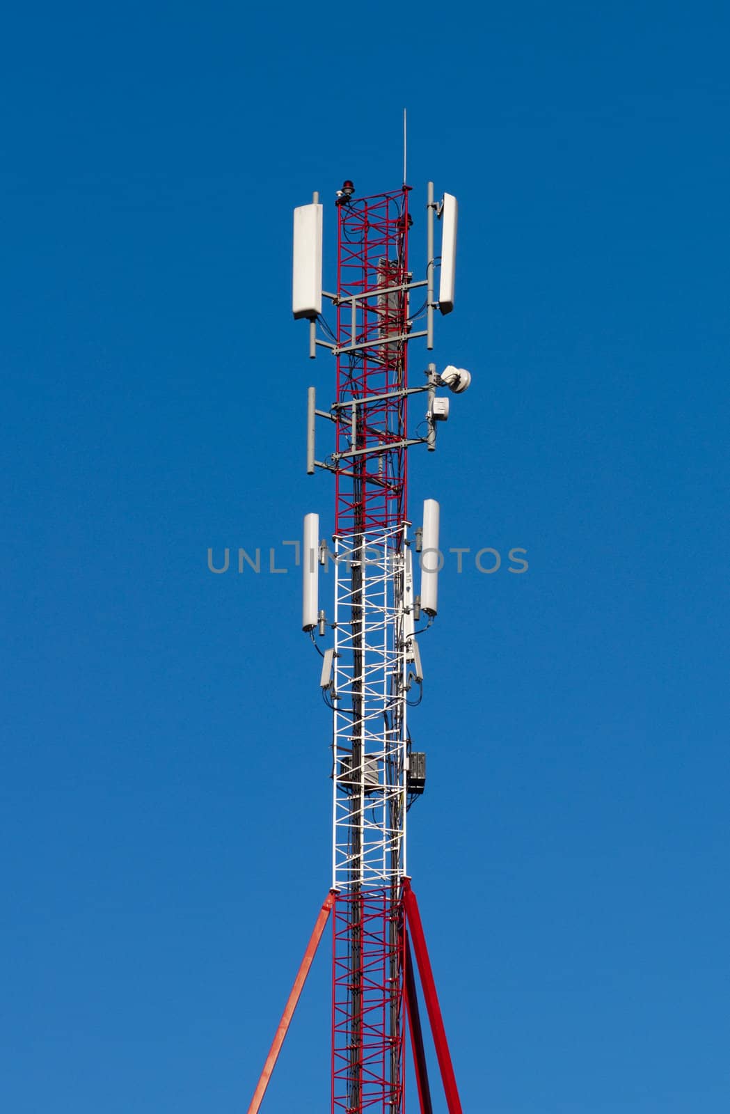 High resolution image. Detail of a transmitter tower against clear blue sky.