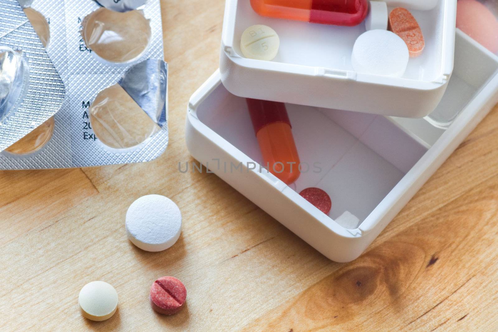 Tablets, capsules and pills sorted in pillboxes for daily use as medication