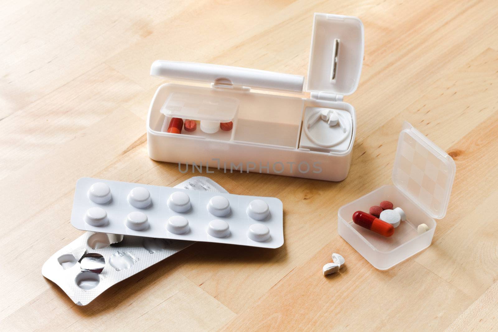 Blisters with pills and travel pillbox with pillcutter 