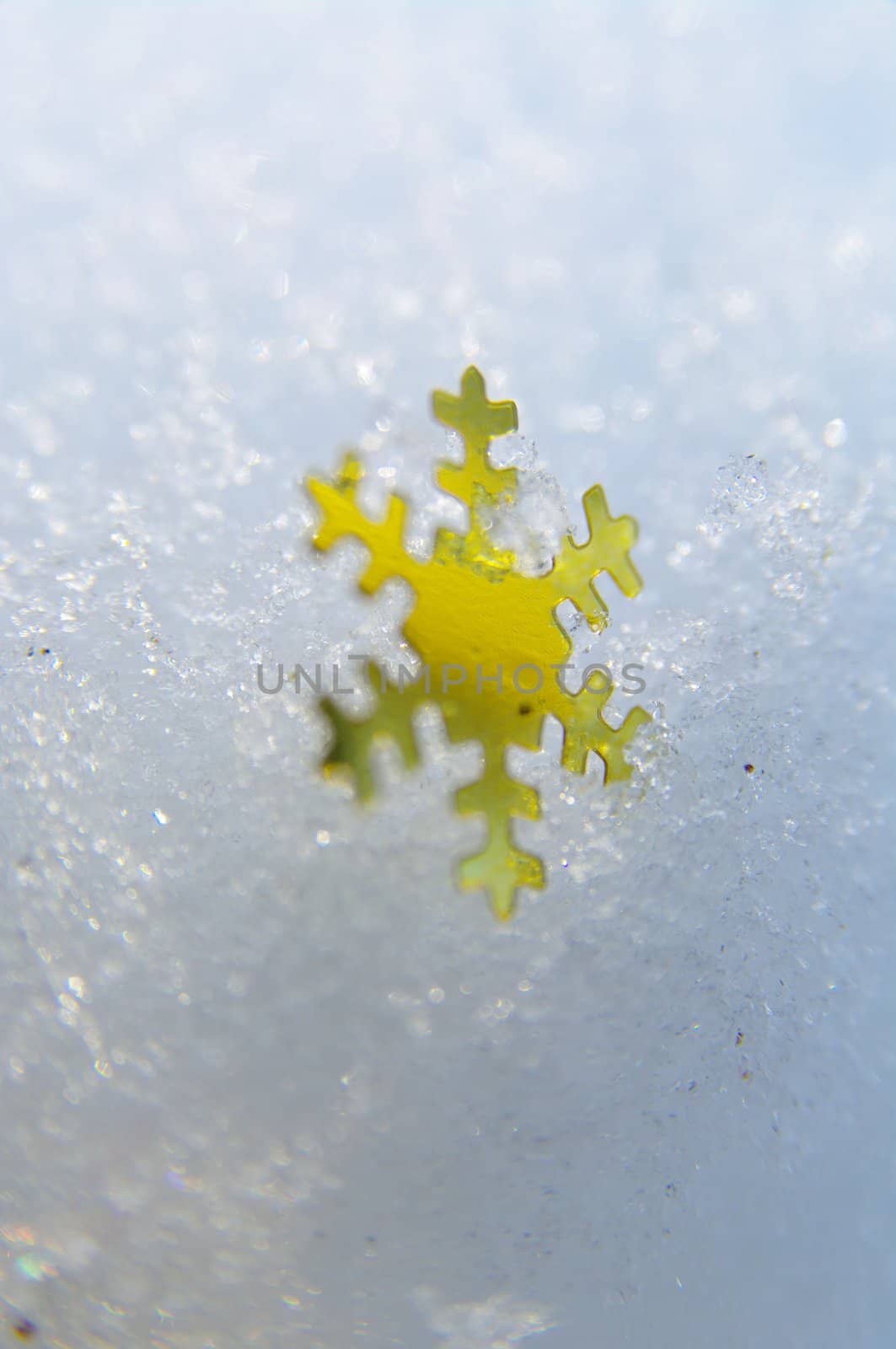 golden snowflakes on a real snowy icy surface