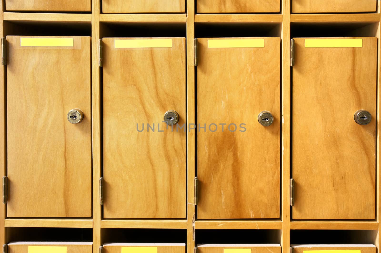 Wooden mailboxes with metal lock in office building or school.