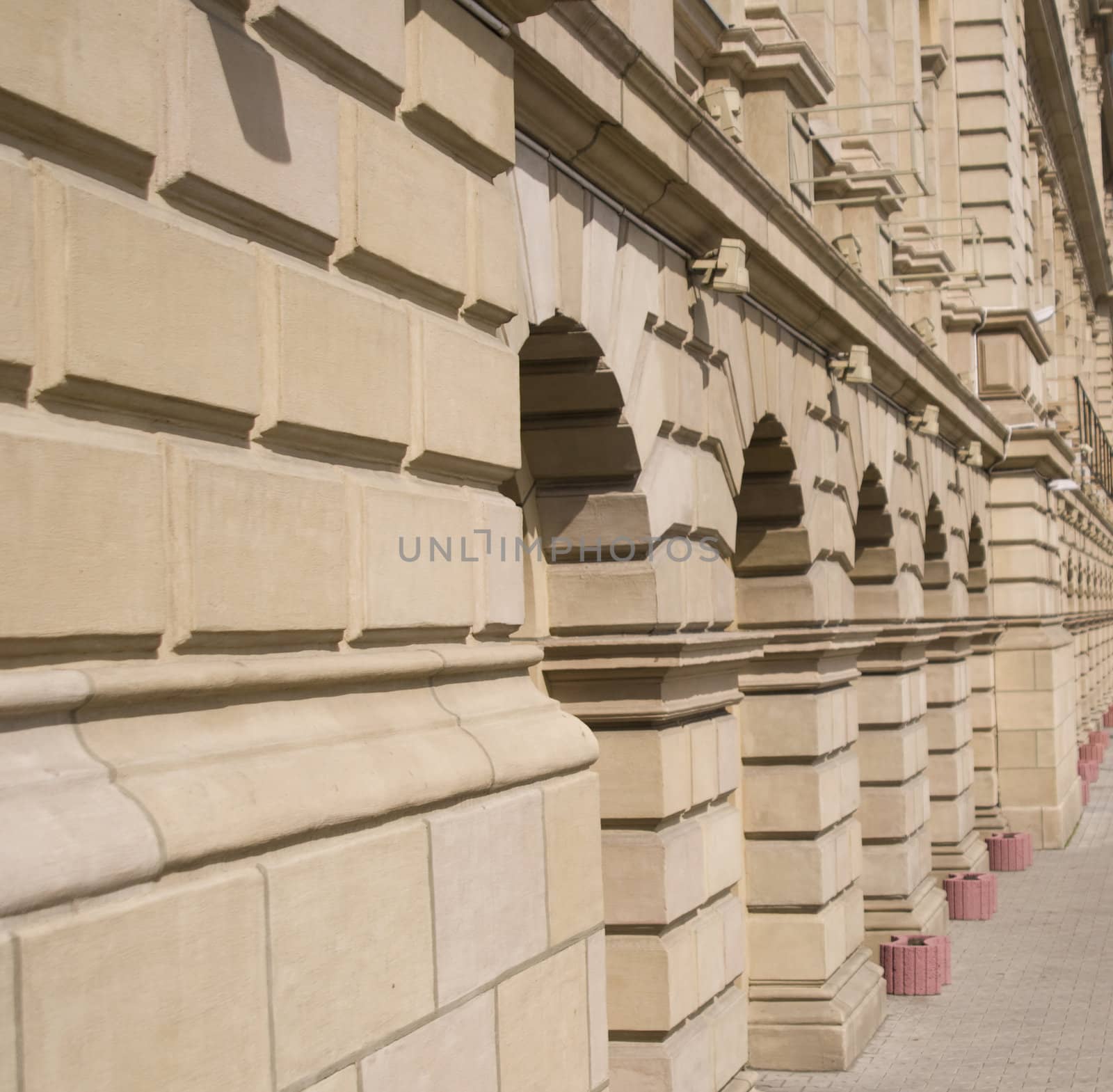 Facade of a city building. City street. A sidewalk part.