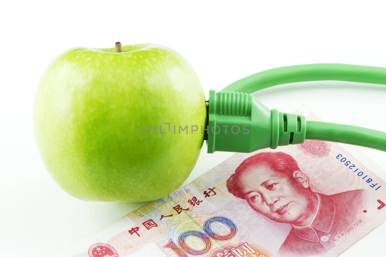 Green apple placed next to Chinese yuan currency emphasize China's fresh support of energy innovation