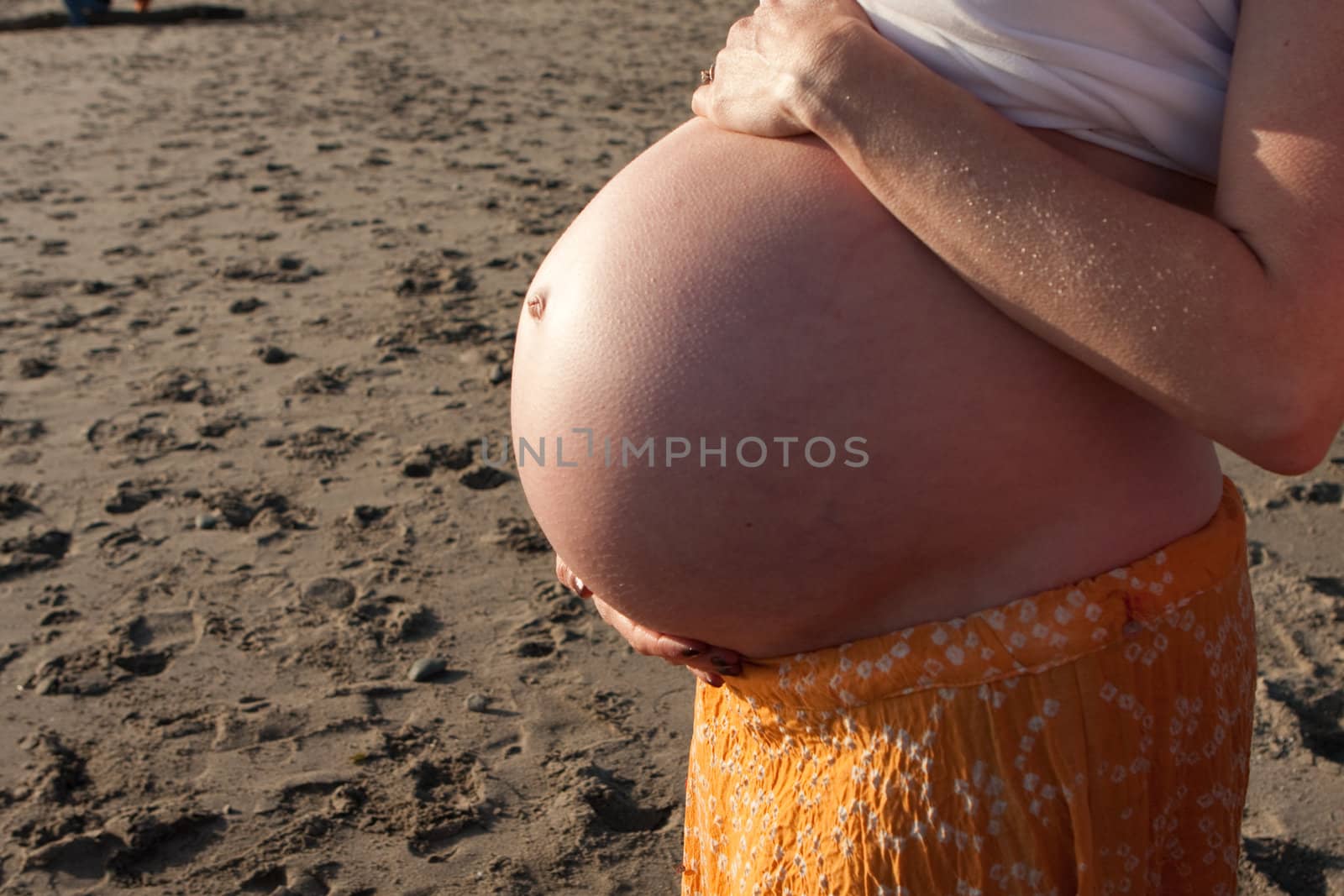 8 month pregnant tummy at the beach, no face.