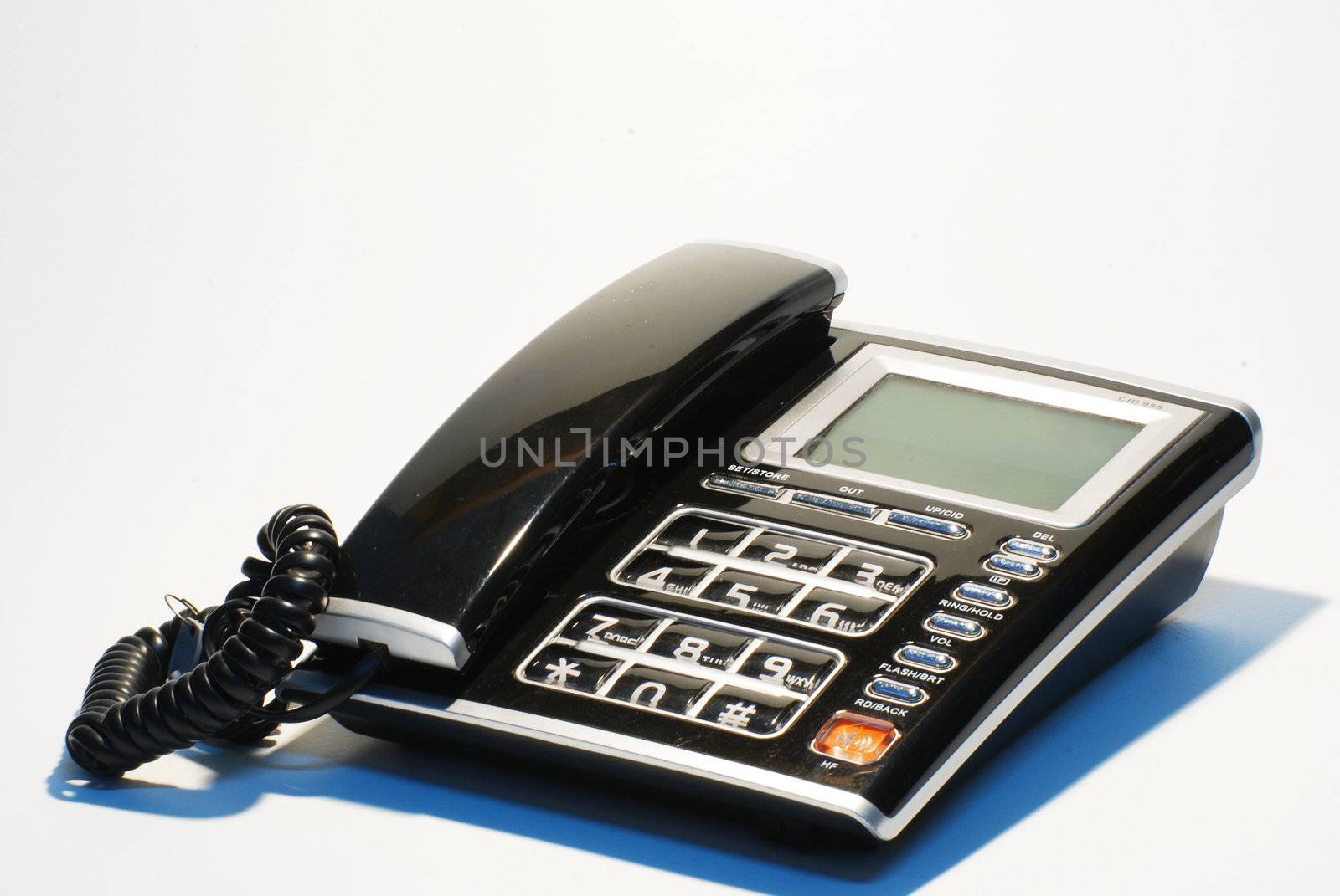 Photo of an office telephone LCD screen with the words Contact Us isolated on background. 

