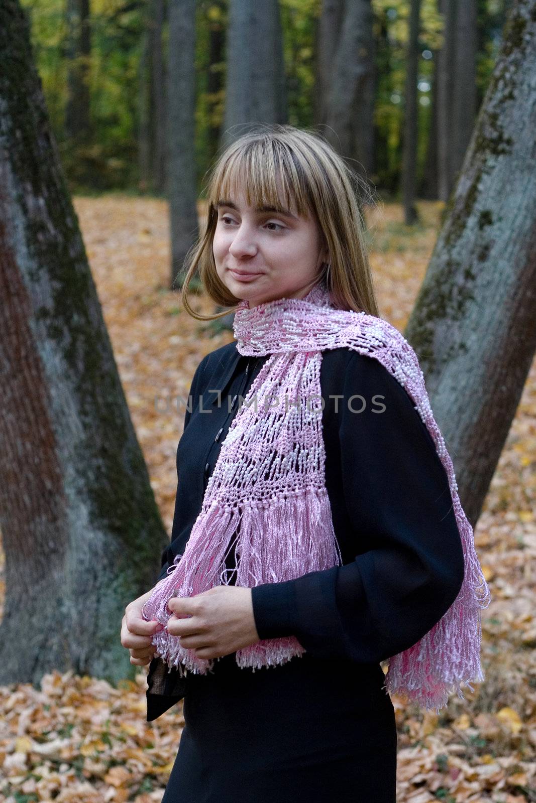 Portrait of the beautiful girl in autumn forest. 
