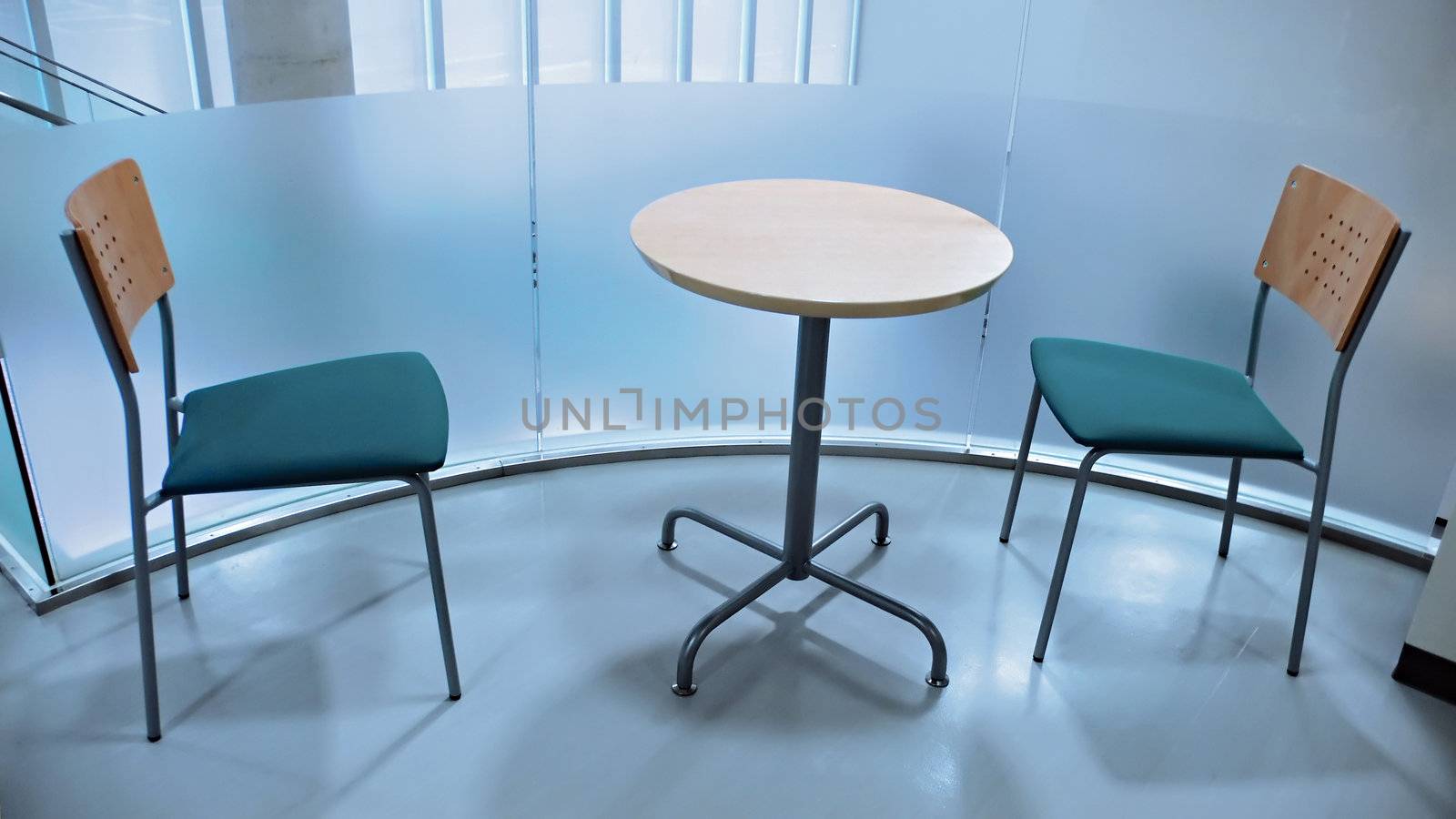 two chairs and round table in modern office interior