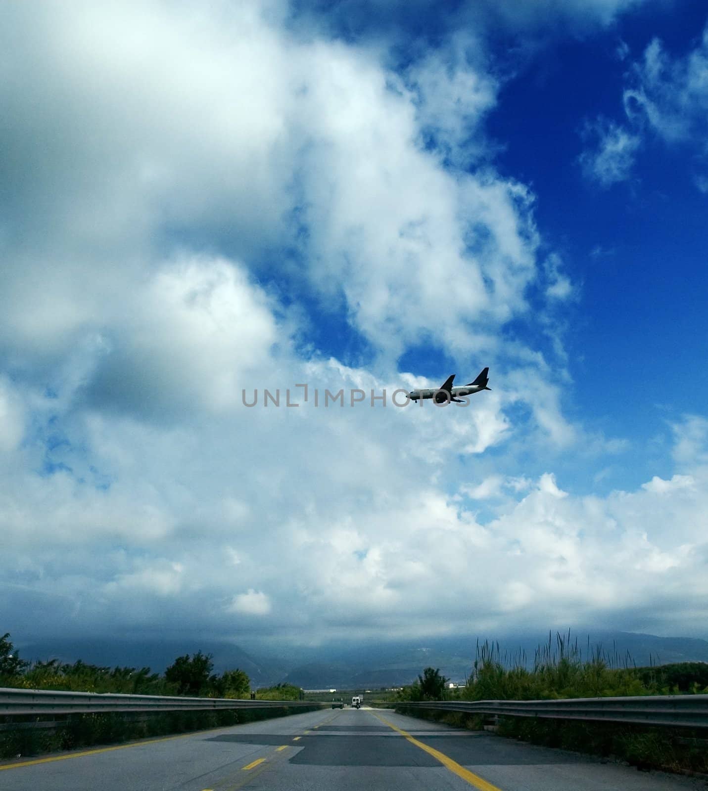 Airplane landing over highway
