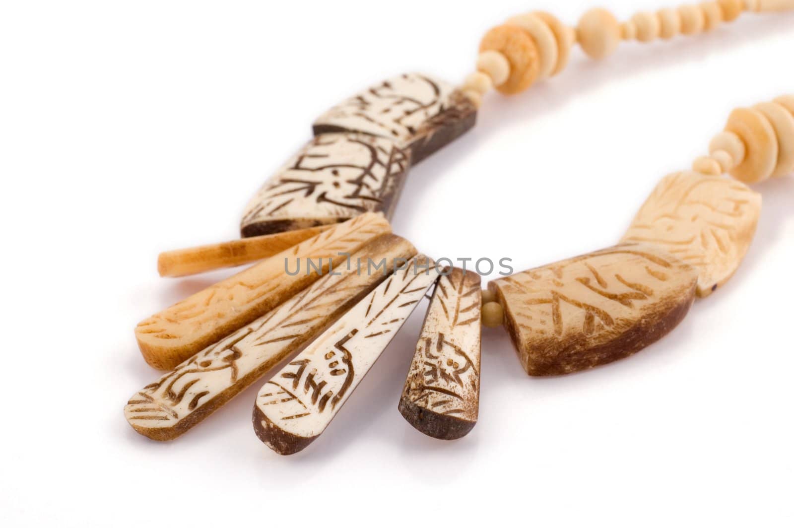 Ethnic necklace isolated on white made up of etched bones