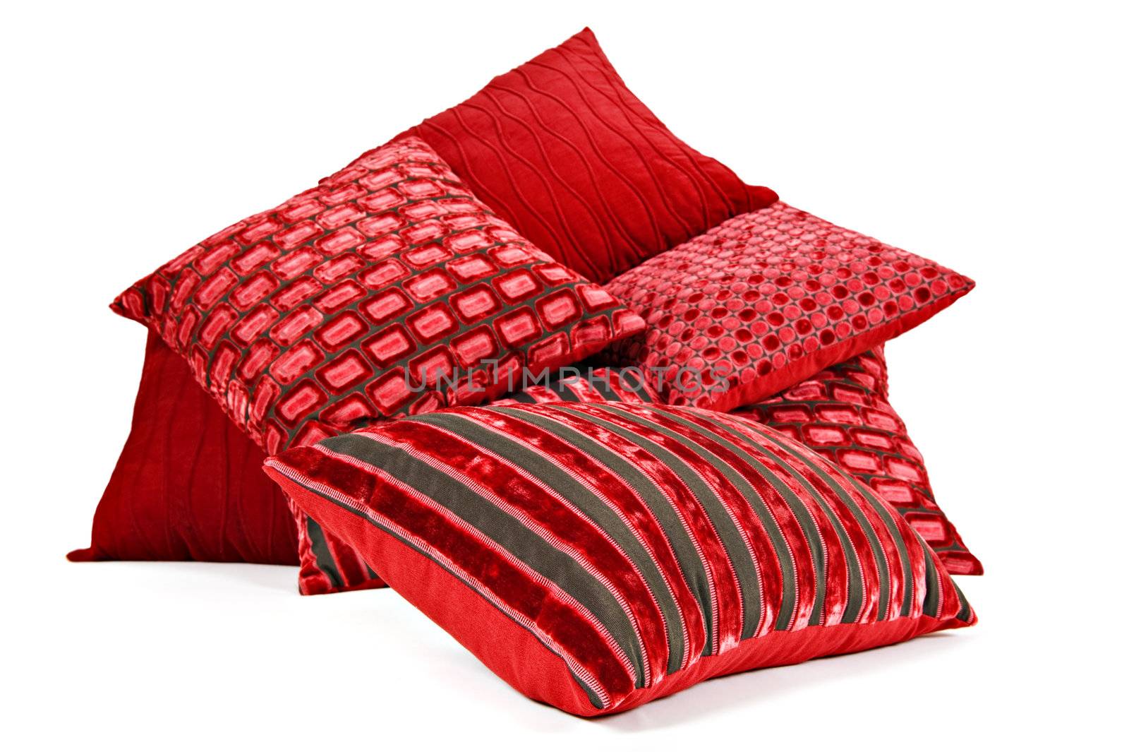 Red cushions stacked up on a white background with space for text