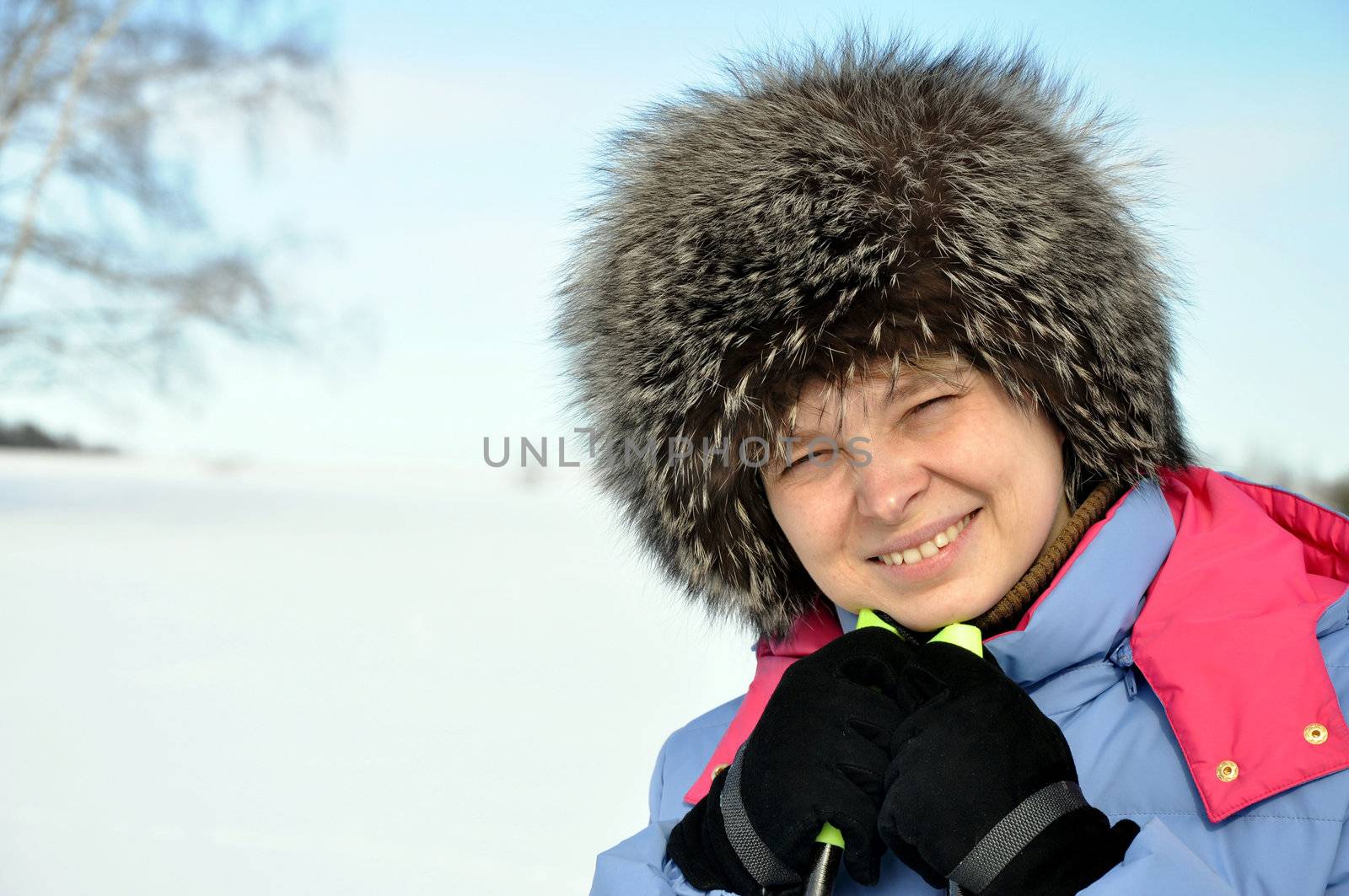  Attractive woman with ski over winter background in january