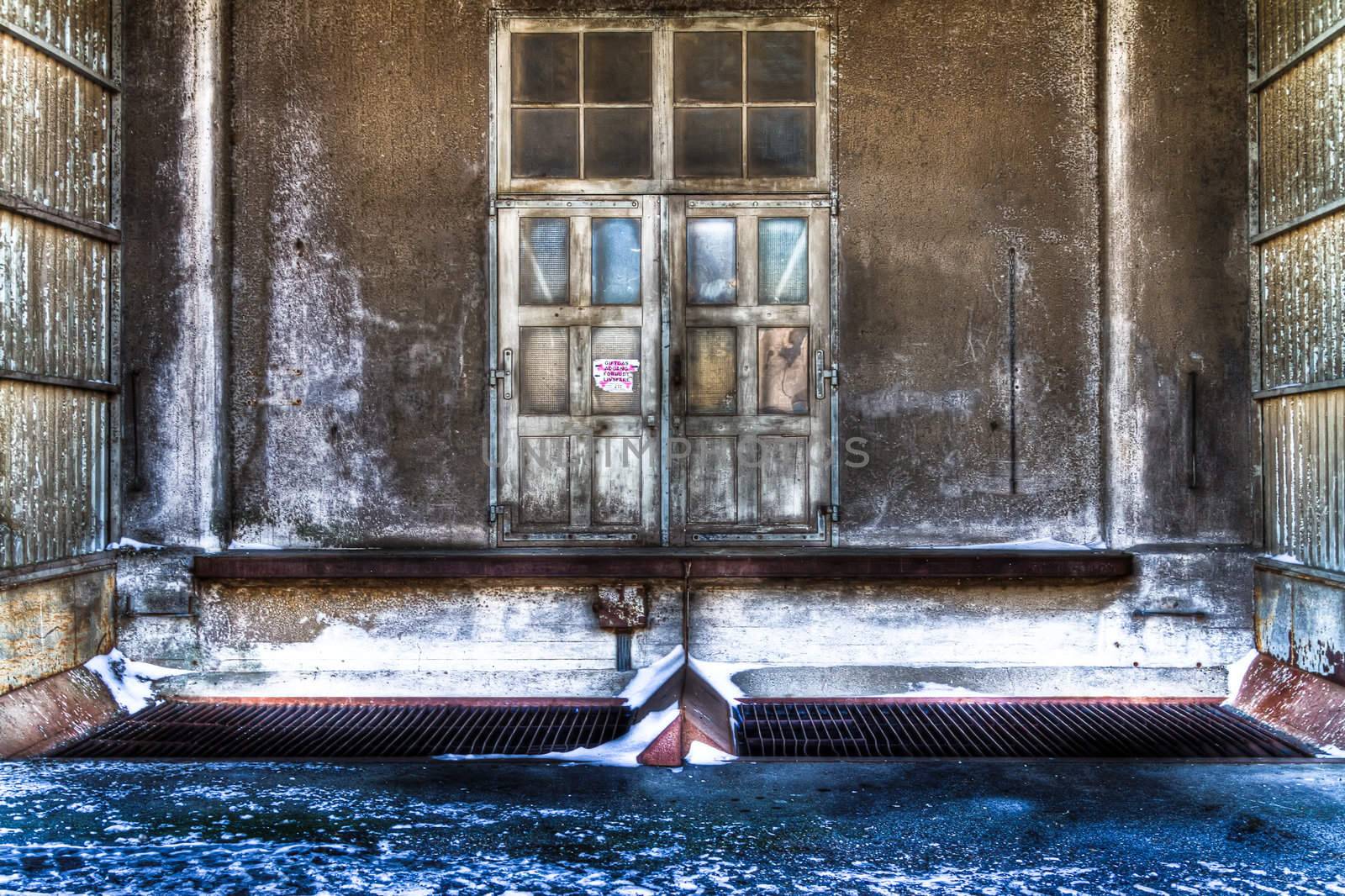 Entrance to old sinister building with snow