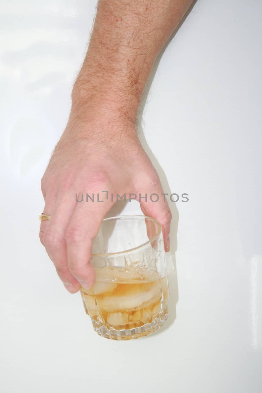 man holding alcoholic drink in a glass