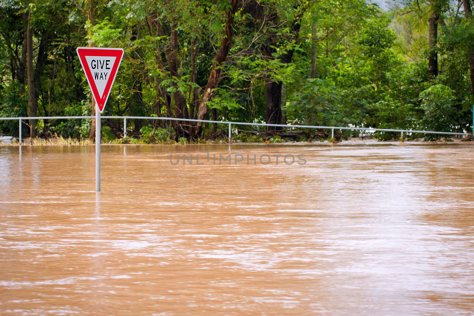 Very flooded road and give way sign in Queensland, Australia