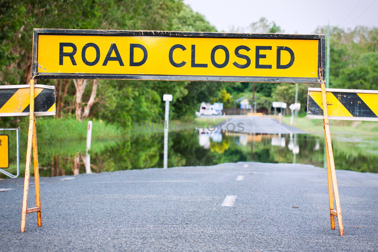 A road closed sign on a flooded road in Queensland, Australia