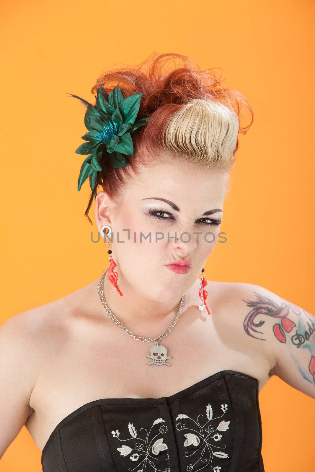 Retro-styled woman on orange background shrivels her nose