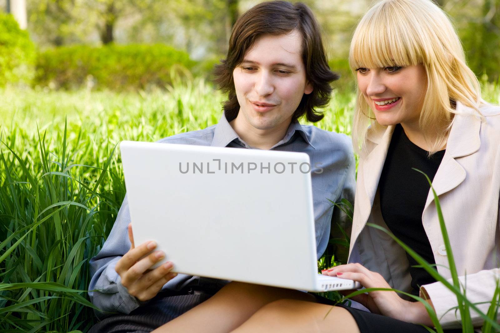 girl and boy laugh with laptop