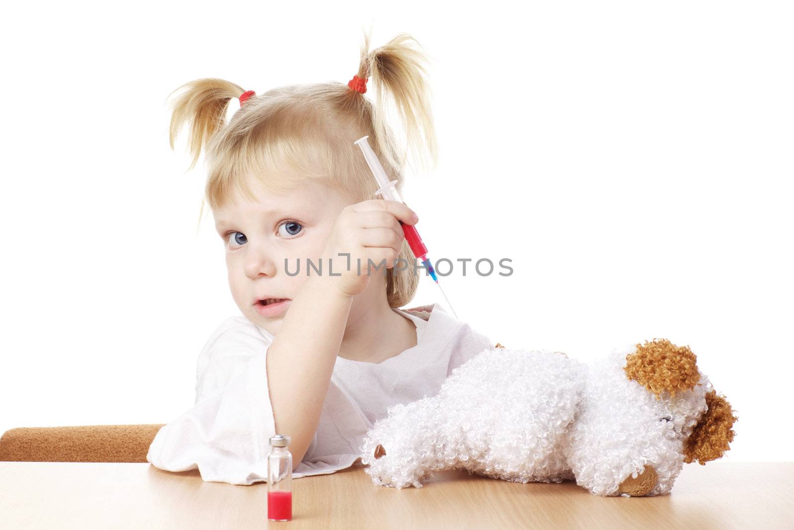 child playing as a doctor with syringe