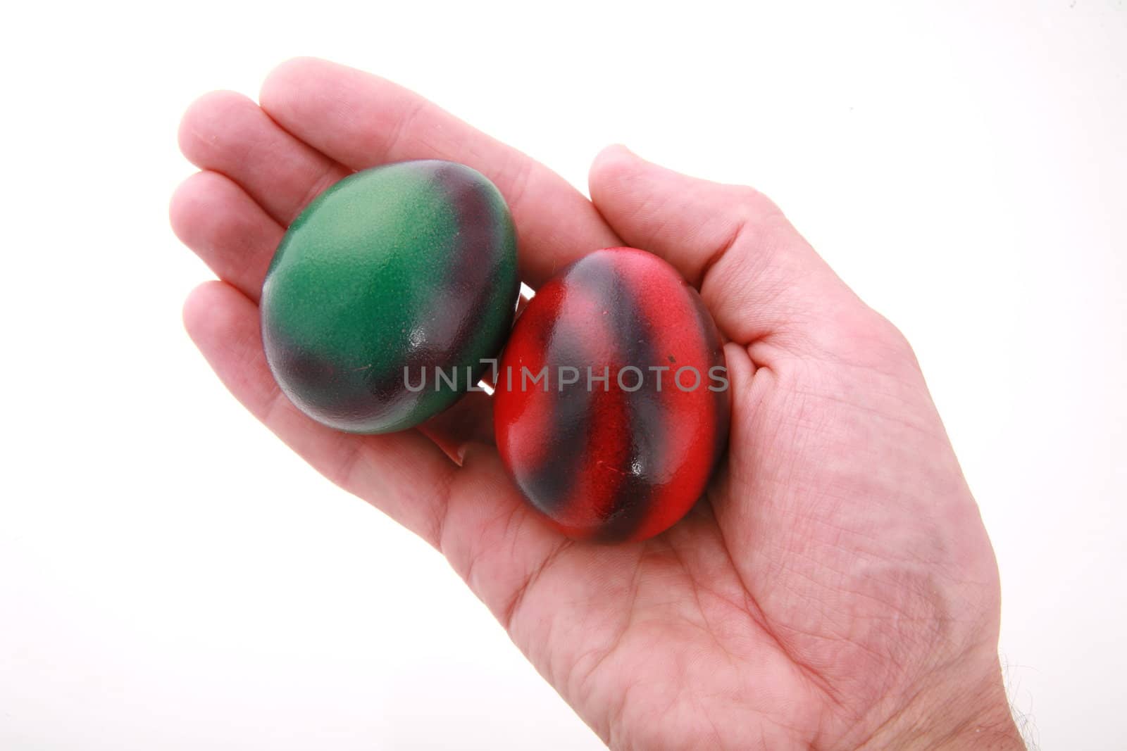 Hand holding easter egg isolated on white