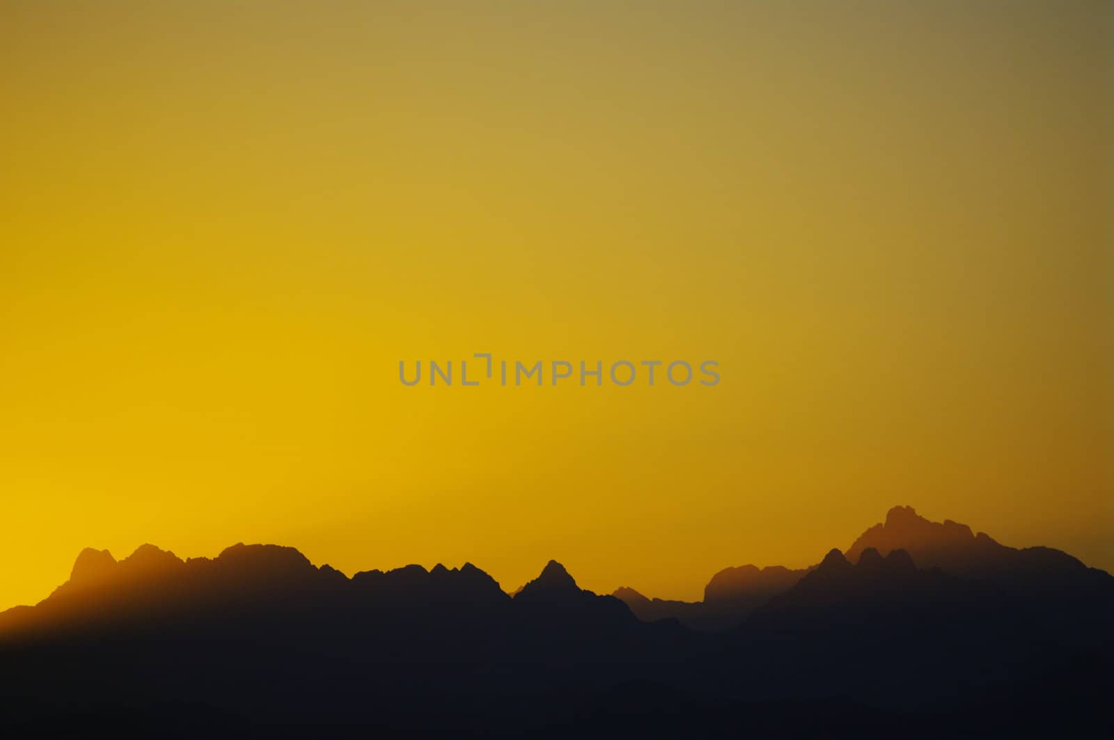 sunset in the desert mountain silhouettes in background.....