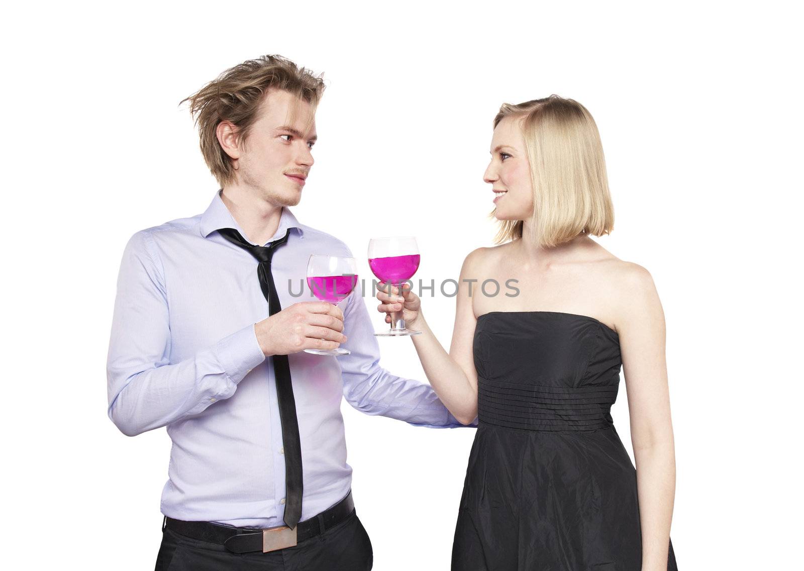 Young couple toasting with pink drink. Two people drinking. Studio photo., isolated.