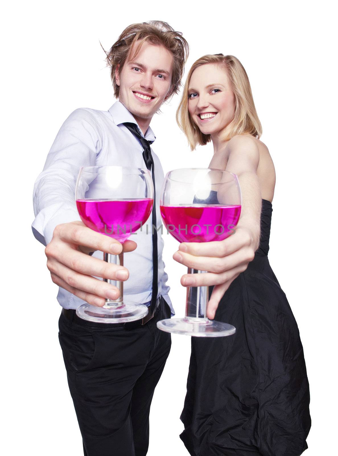 Young couple toasting with pink drink. Selective Focus. Studio photo, isolated.