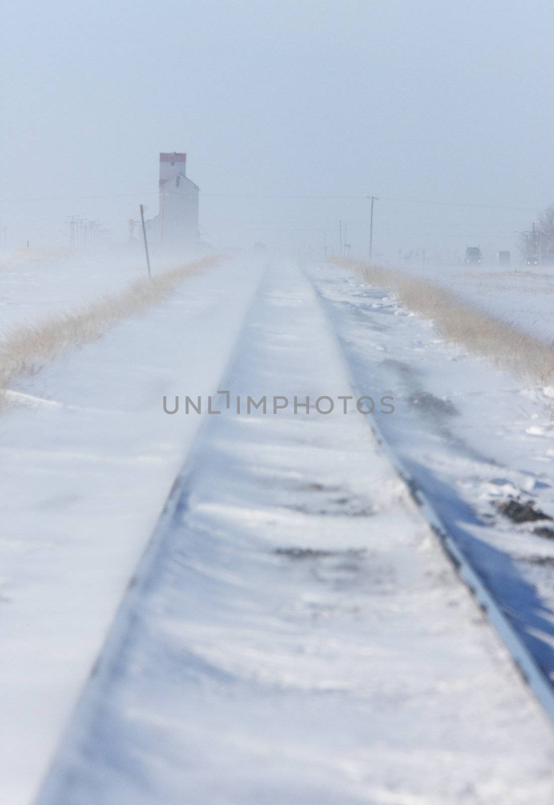 Train Tracks and Grain Elevator in Blizzard Saskatchewan  by pictureguy