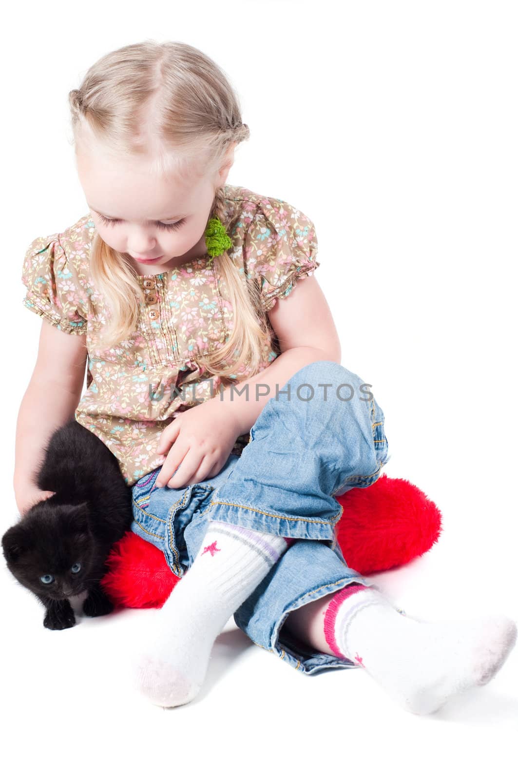 Little girl playing with kitten by anytka