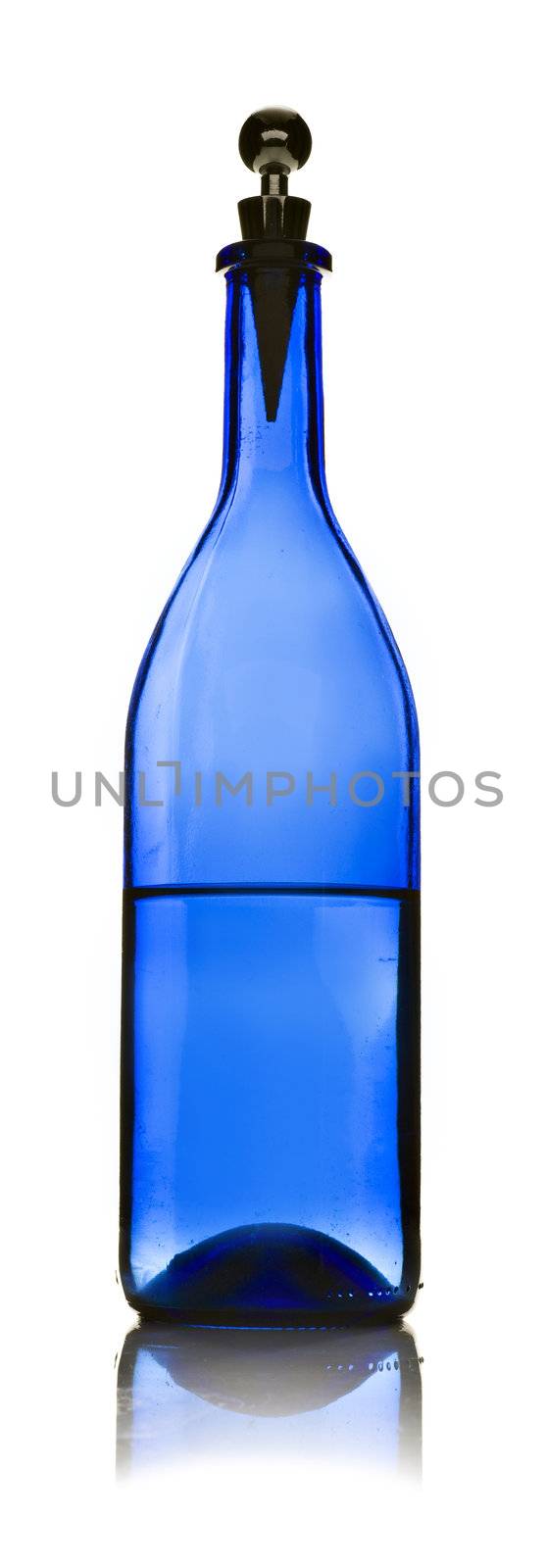 One blue glass bottle with water on a white background
