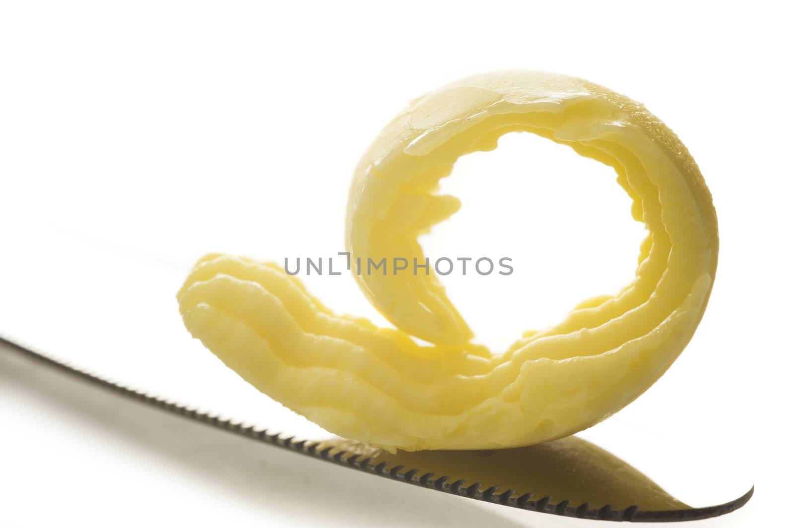Butter on knife on white background with space for text